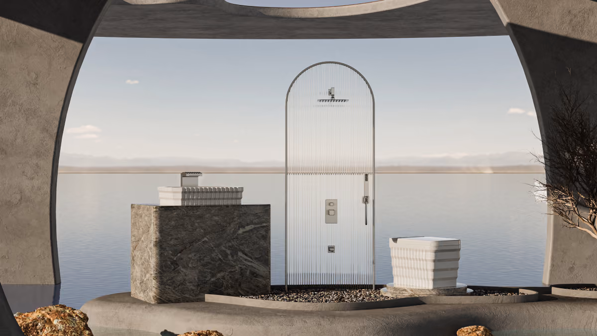 Outdoor shower with arched frame, stone washstand and white toilet overlooking a calm lake